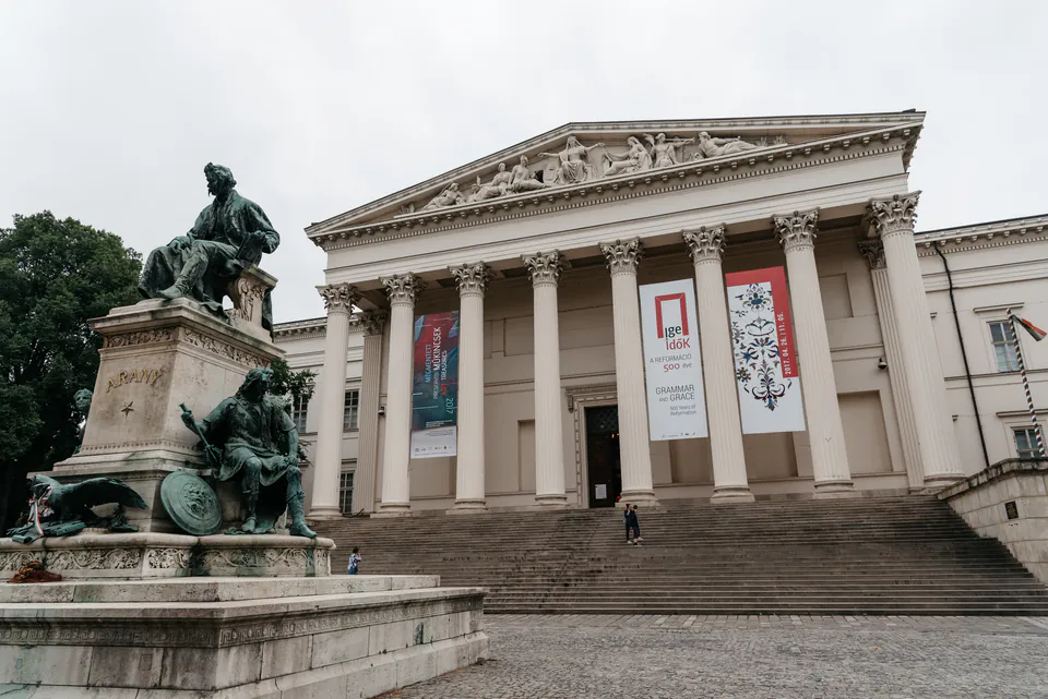 Hungarian National Museum facade with eight Corinthian columns, stone steps, and commemorative statue