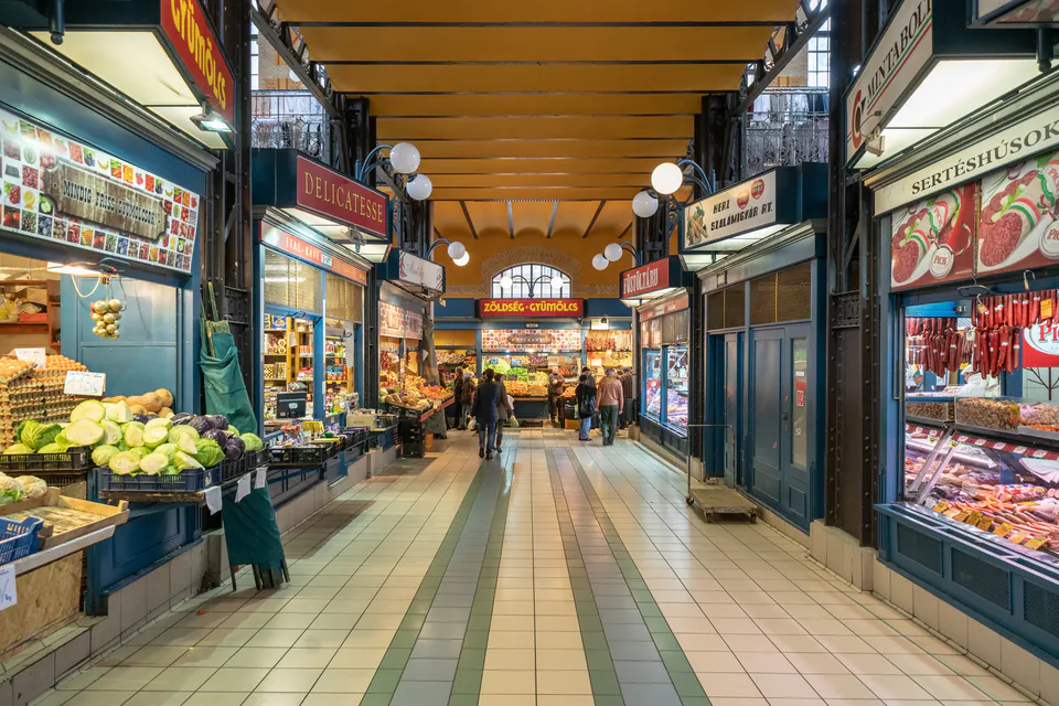 Interior corridor of historic Great Market Hall with produce stands, delicatessens and meat shops