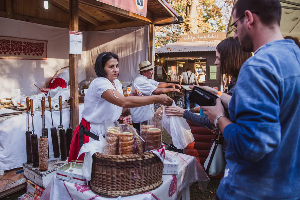 Market vendor in Budapest accepting cash payment