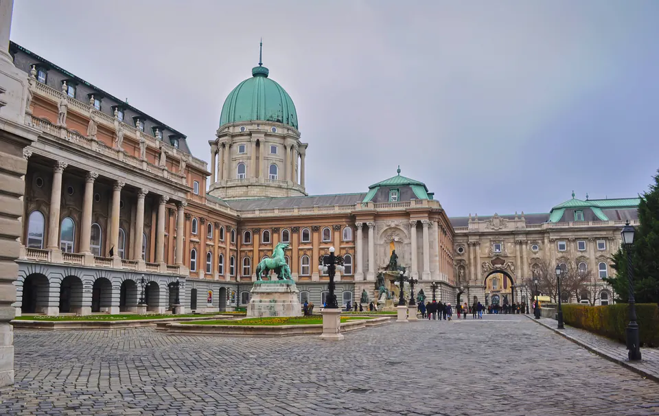 Ornate baroque courtyard of Buda Castle with tourists exploring