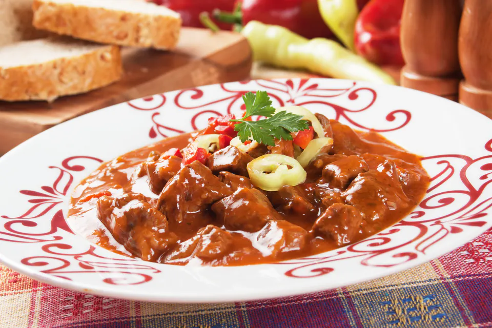 Traditional Hungarian goulash served in ceramic bowl with bread