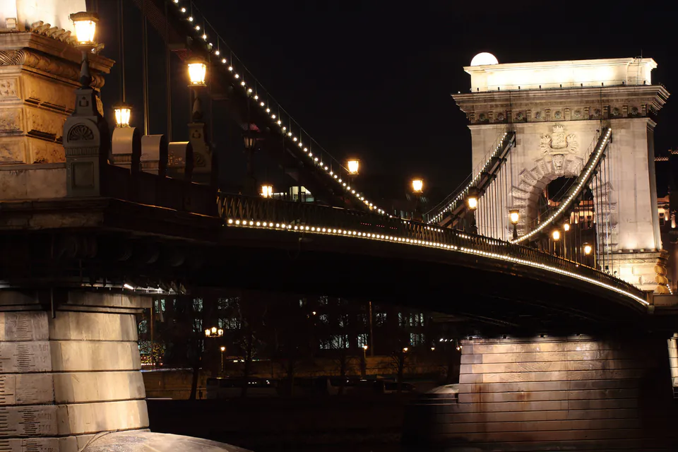 Budapest Chain Bridge illuminated at night with Buda Castle in background