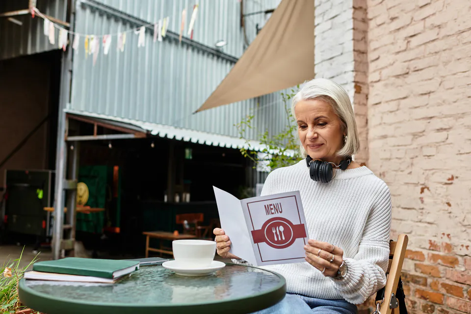 Tourist carefully reviewing a restaurant menu with clearly displayed prices