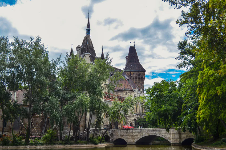Vajdahunyad Castle's Gothic spires and towers rise above trees in Budapest's City Park