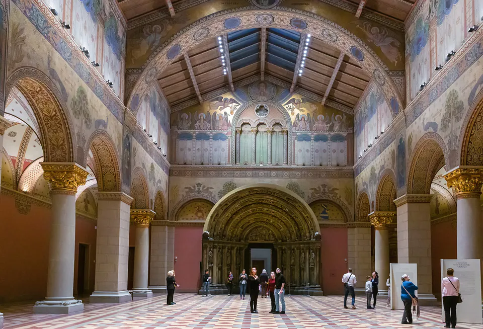 Ornate Romanesque Hall interior with gilded columns, frescoed walls and vaulted ceiling