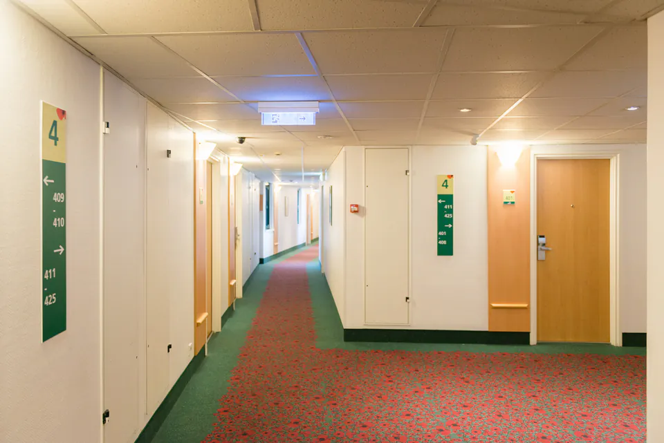 Interior of a budget-friendly hostel common area in Budapest with travelers socializing