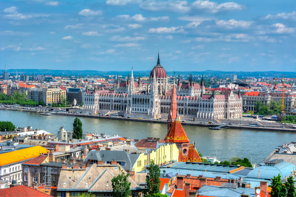 Budapest Parliament building and Chain Bridge illuminated at sunset over Danube River