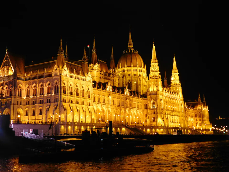 Budapest Parliament building illuminated at night from Danube river cruise