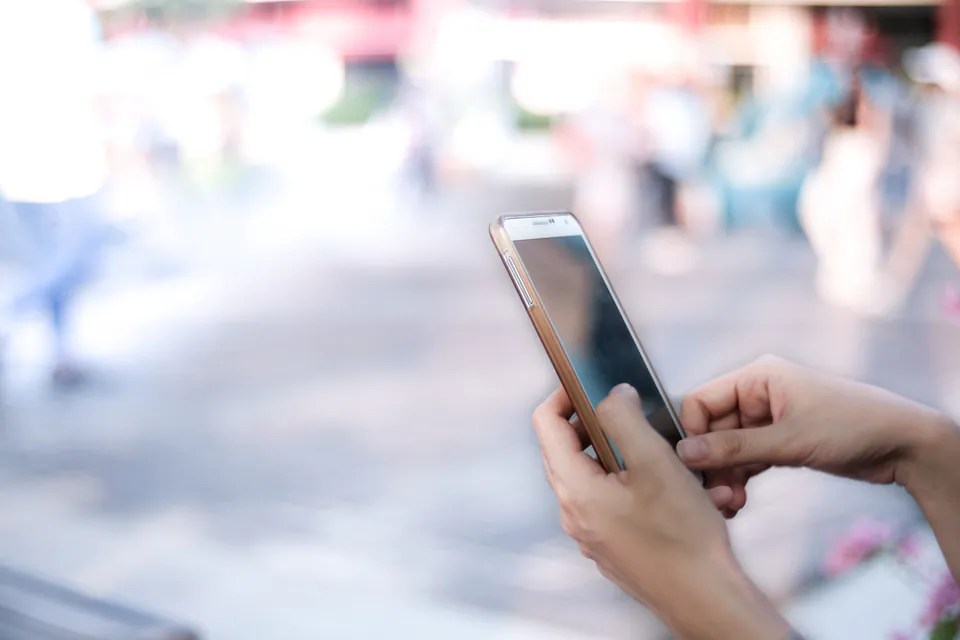 Tourist using smartphone BudapestGO app to purchase digital travel pass