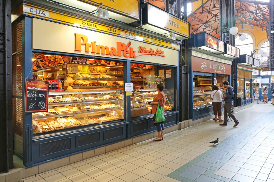 Modern PrimaPék bakery storefront with display cases of pastries in Budapest's Great Market Hall
