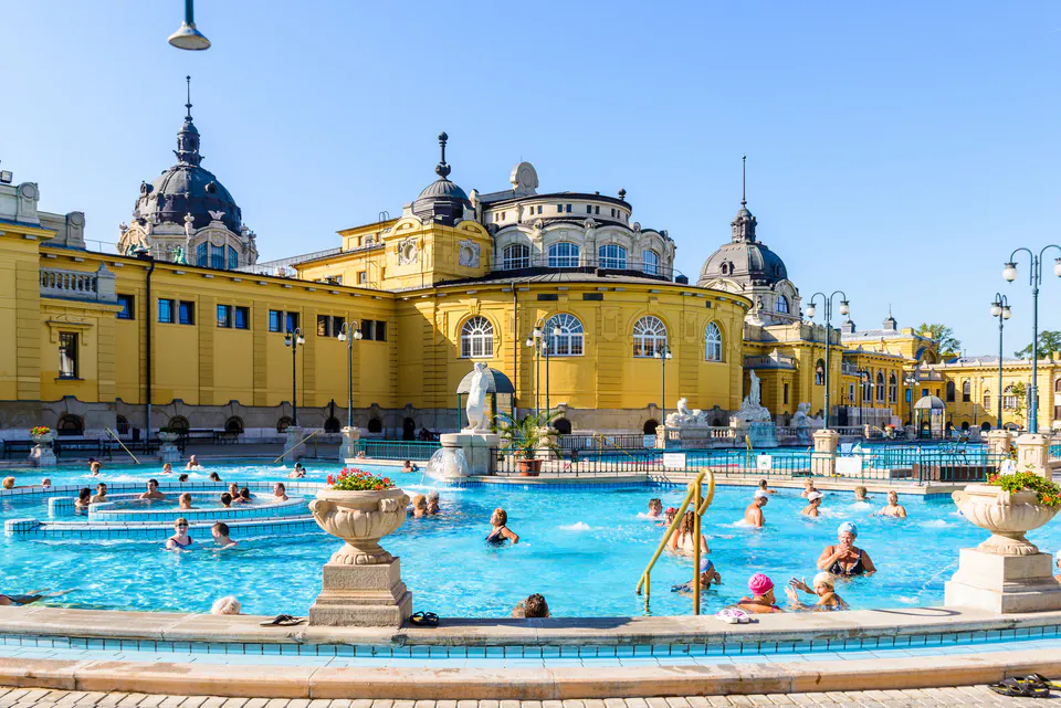 Outdoor pools at Széchenyi Thermal Baths with yellow Neo-baroque building in background