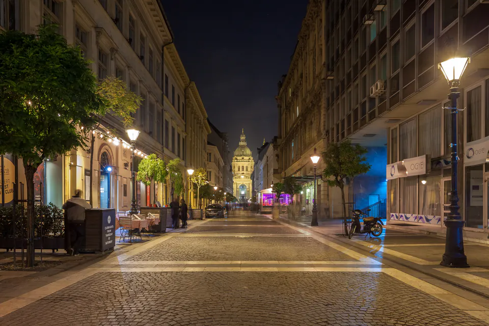 Well-lit evening street scene in Budapest's District V
