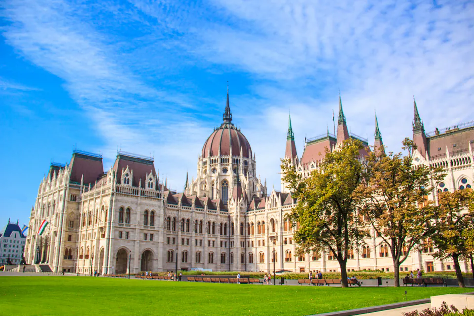 Hungarian Parliament building reflected in Danube waters during golden hour