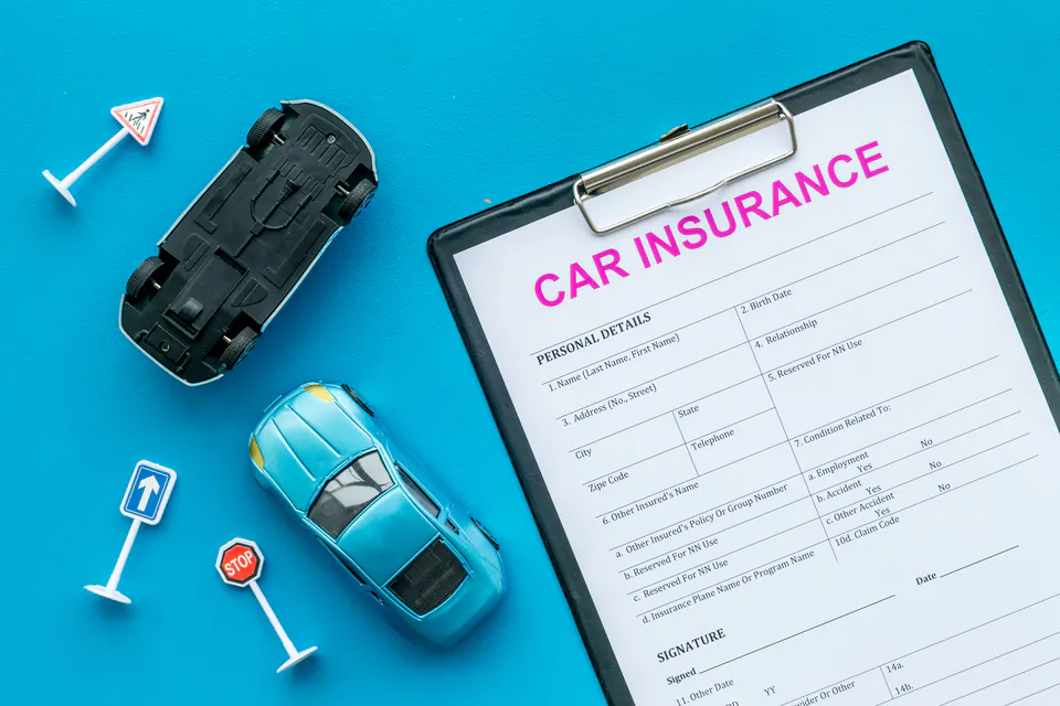 Car insurance documents and policy papers on desk