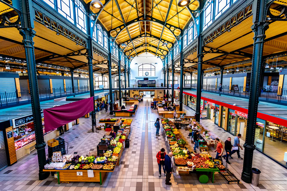 Interior of Budapest's Central Market Hall showing produce vendors and historic architecture