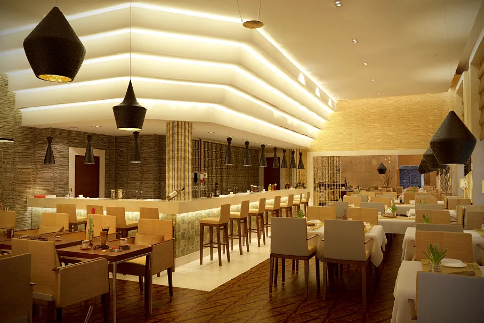 Modern restaurant interior with warm lighting, wooden floors and cream-colored seating