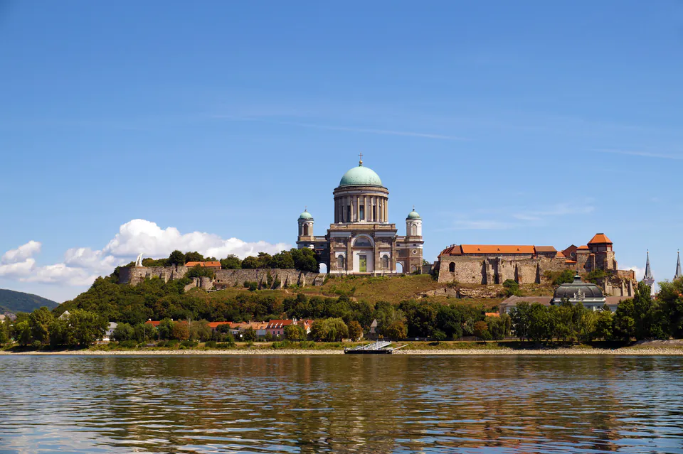 Panoramic view of Esztergom Basilica and castle complex atop hill overlooking Danube River