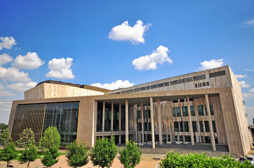 Modern concrete building of Ludwig Museum with glass walls and pillared entrance