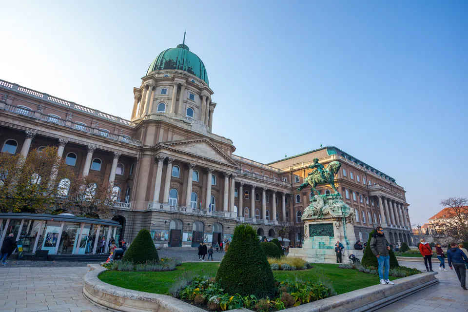 Neoclassical facade of Buda Castle with green copper dome and ornate columns