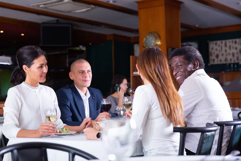 Diners enjoying an upscale restaurant experience in smart casual attire
