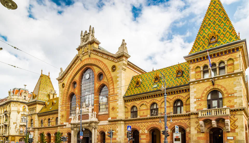 Ornate facade of Great Market Hall with colorful Zsolnay tile roof and neo-Gothic arched entrance