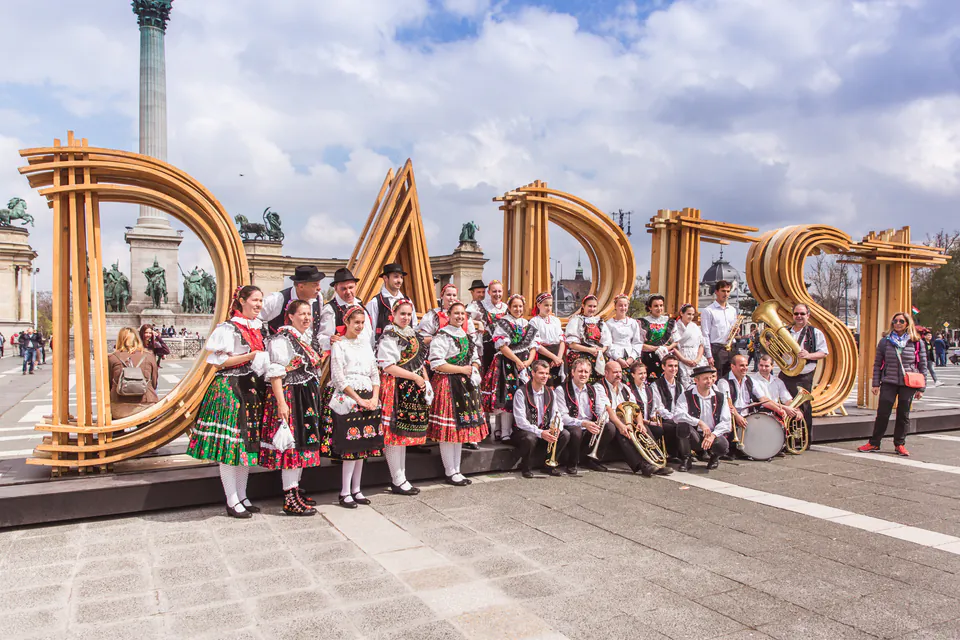 Traditional musicians and performers in folk costumes gathered at Heroes' Square in Budapest