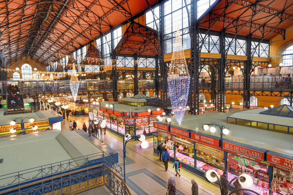 Interior view of Budapest's Great Market Hall showing ornate iron architecture and food vendor stalls