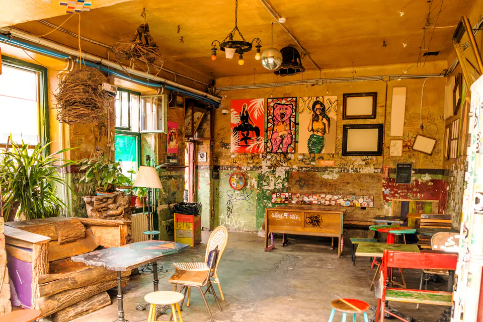 Eclectic interior of Szimpla Kert with vintage furniture, artistic decorations and market stalls
