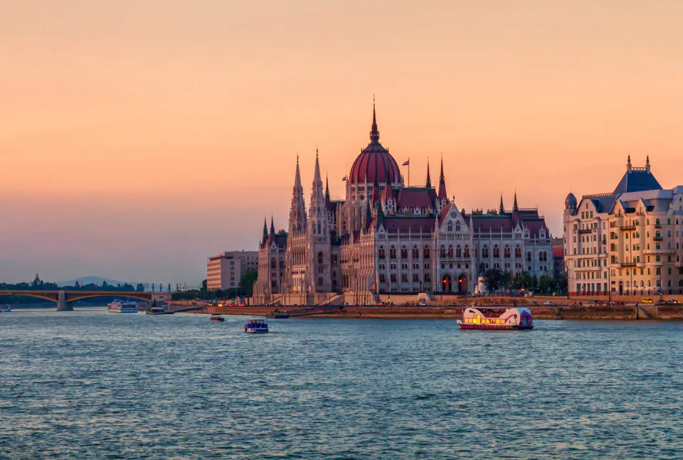 Budapest Parliament building during golden hour sunset from river view