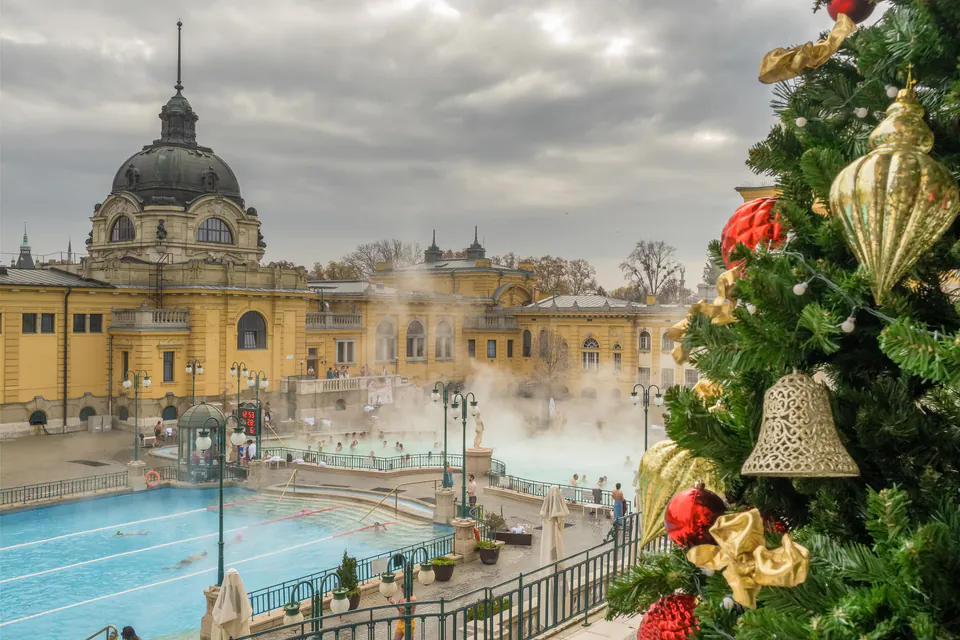 Széchenyi thermal bath outdoor pools with steam rising and people relaxing