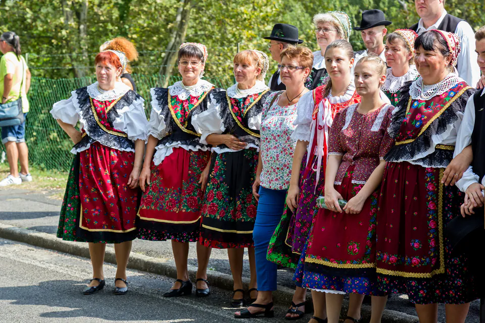 Group wearing traditional Hungarian folk costumes with embroidered dresses and decorative patterns
