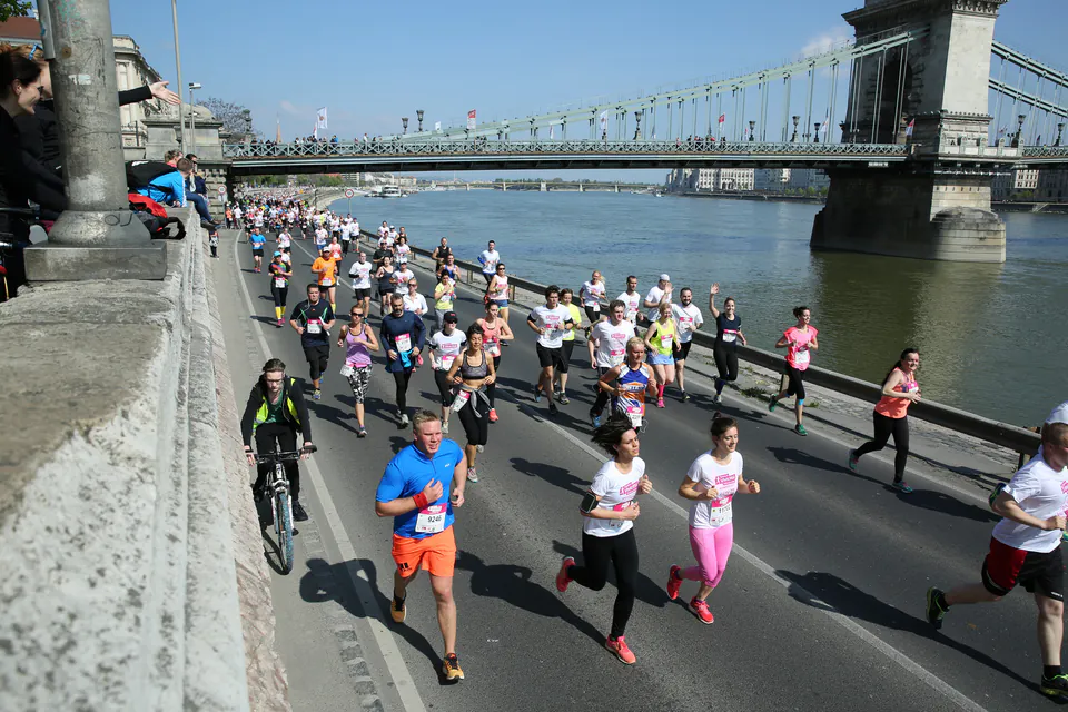 Marathon runners crossing a bridge over the Danube River during Budapest Marathon event