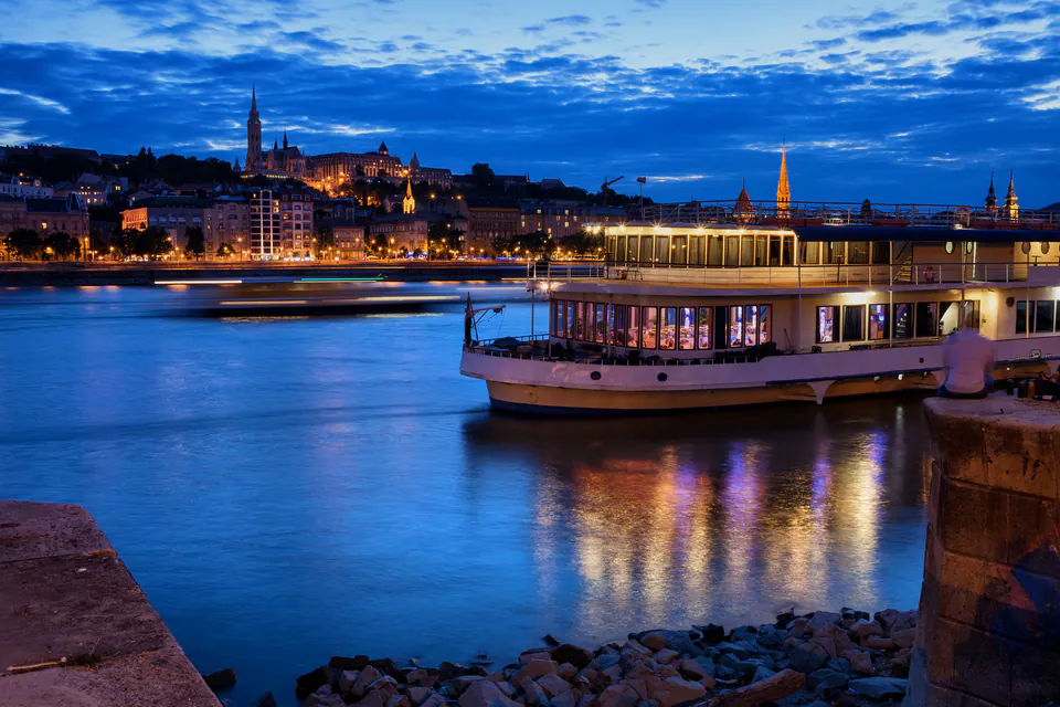 Elegant dinner cruise boat illuminated at night on the Danube