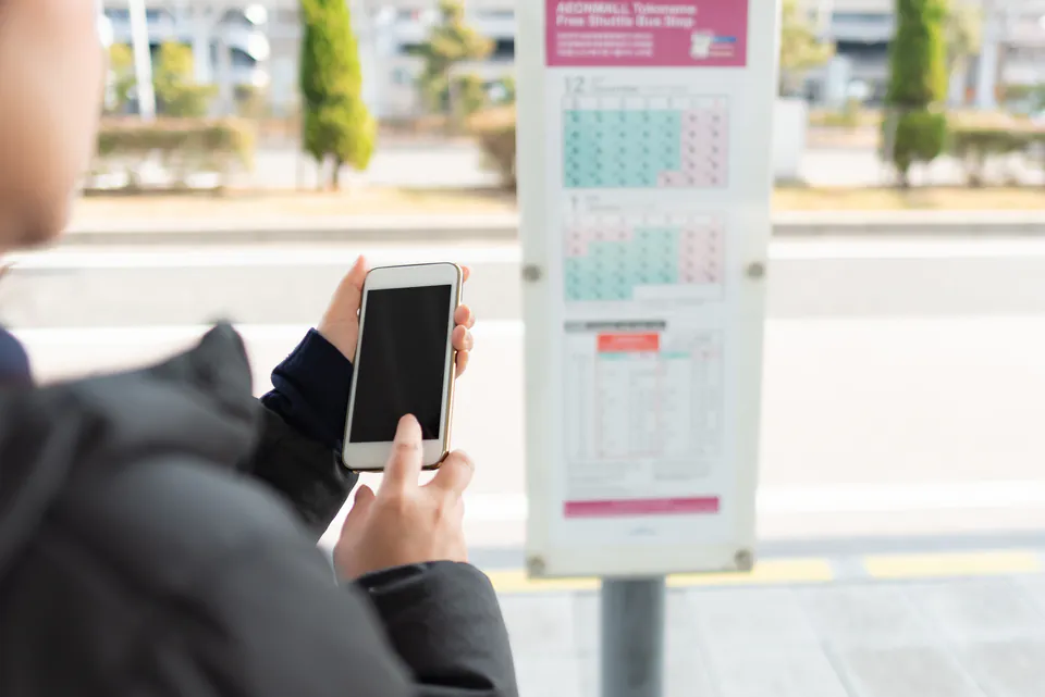 Smartphone showing BKK transport app with route planning and real-time information