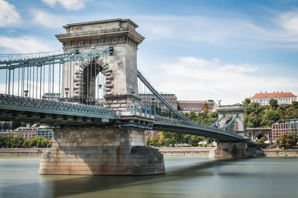 Historic Chain Bridge with stone towers and suspension cables spanning the Danube River in Budapest