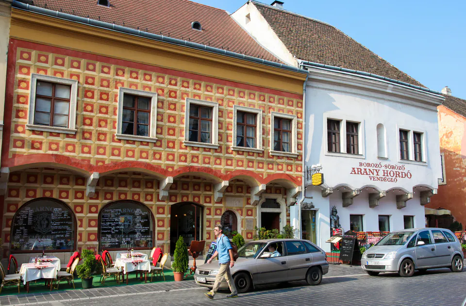 Historic Hungarian restaurant facade with traditional decorative patterns and outdoor seating