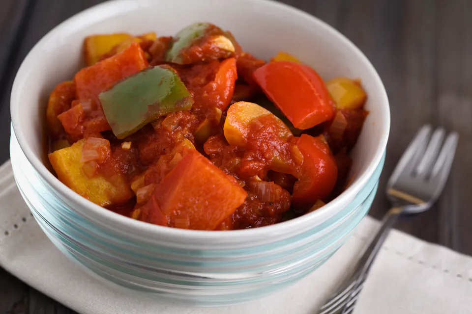 Bowl of colorful Hungarian lecsó stew with peppers, tomatoes and onions in rich sauce