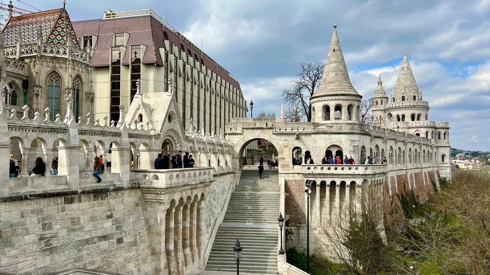 White neo-Romanesque towers and terraces of Fisherman's Bastion with ornate stone staircases and arches