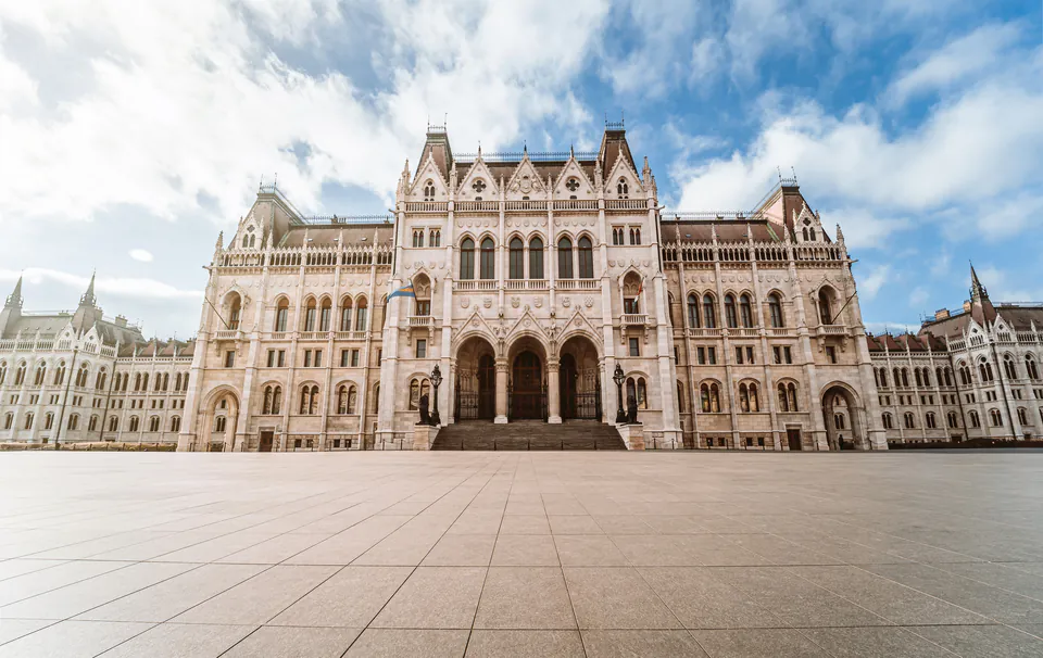 Main entrance facade of the Hungarian Parliament Building with its grand staircase and Gothic architecture