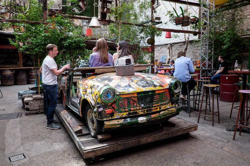 Graffiti-covered Trabant car converted to seating in outdoor courtyard of ruin pub
