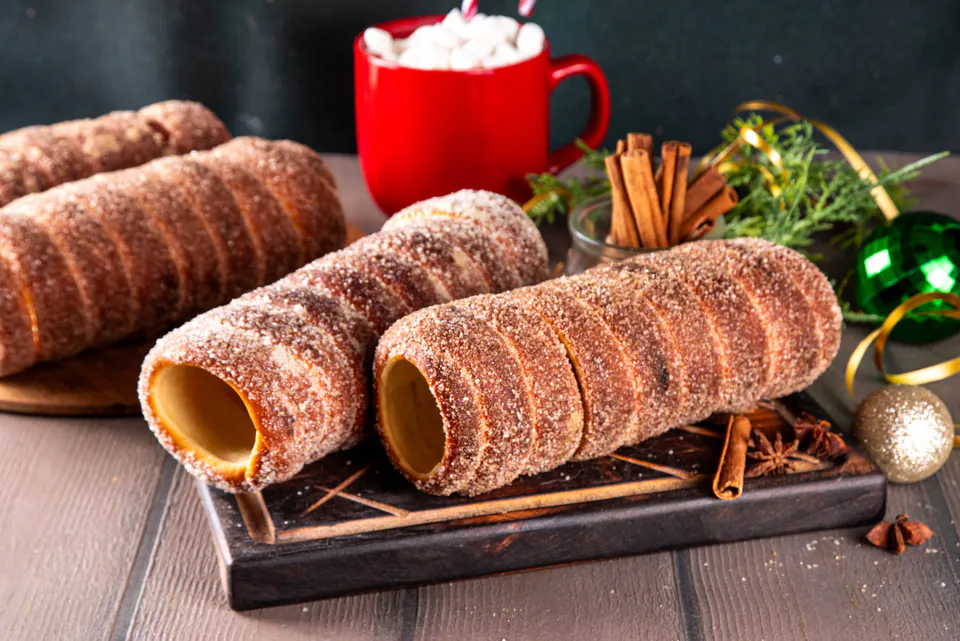 Hungarian chimney cakes (kürtőskalács) with hot chocolate and festive decorations.