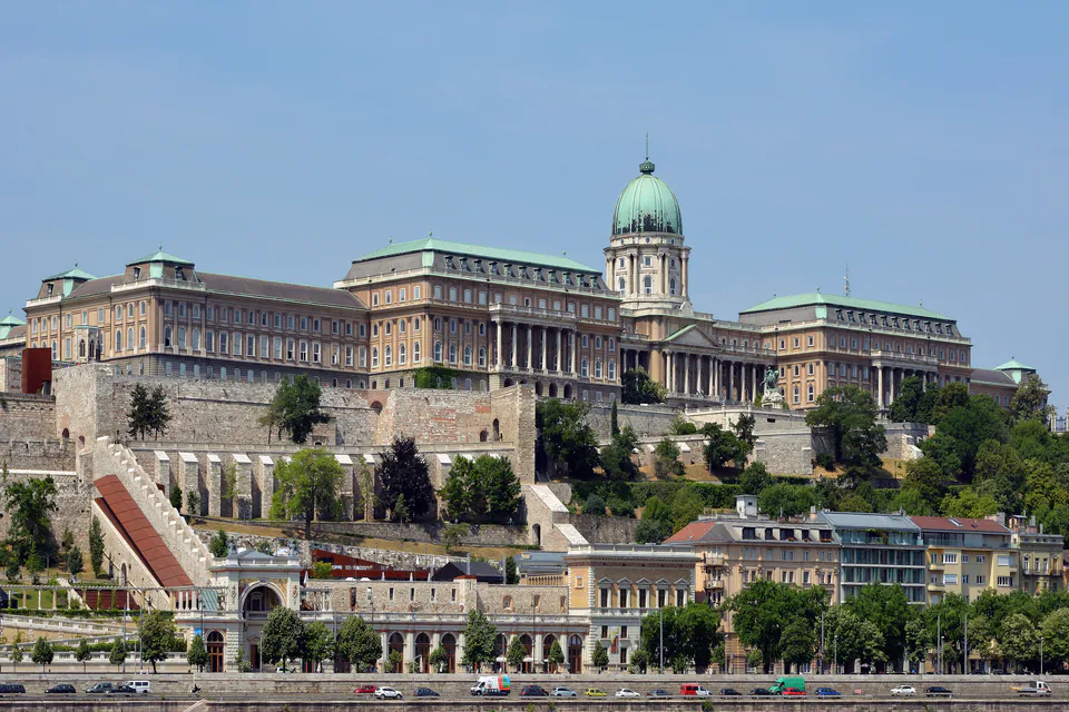 Buda Castle complex with baroque architecture and tourists exploring courtyards