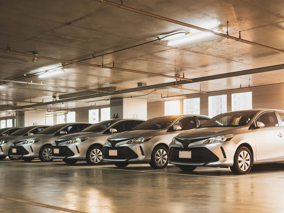 Selection of different rental car models from economy to SUV displayed in parking area