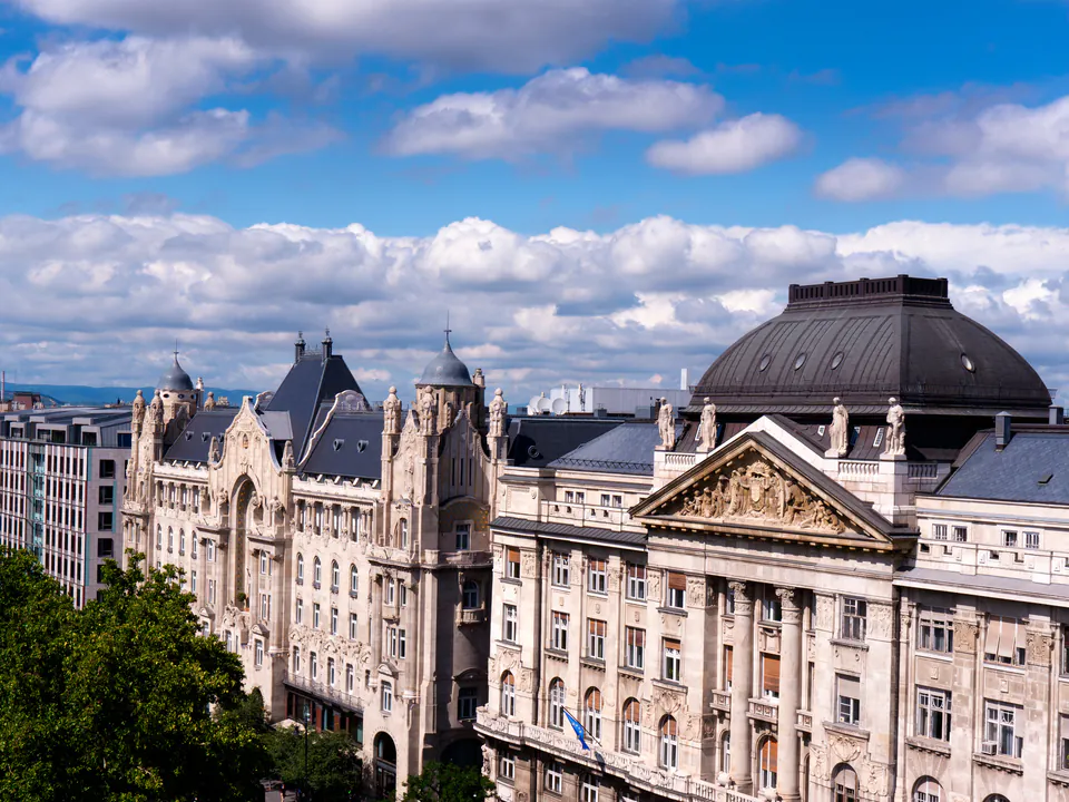 Exterior view of historic Gresham Palace with ornate Art Nouveau architecture and domed roof