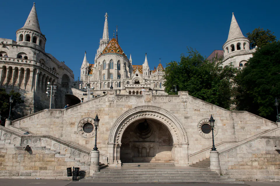 Historic stone staircase and archway leading to Fisherman's Bastion with ornate towers and spires