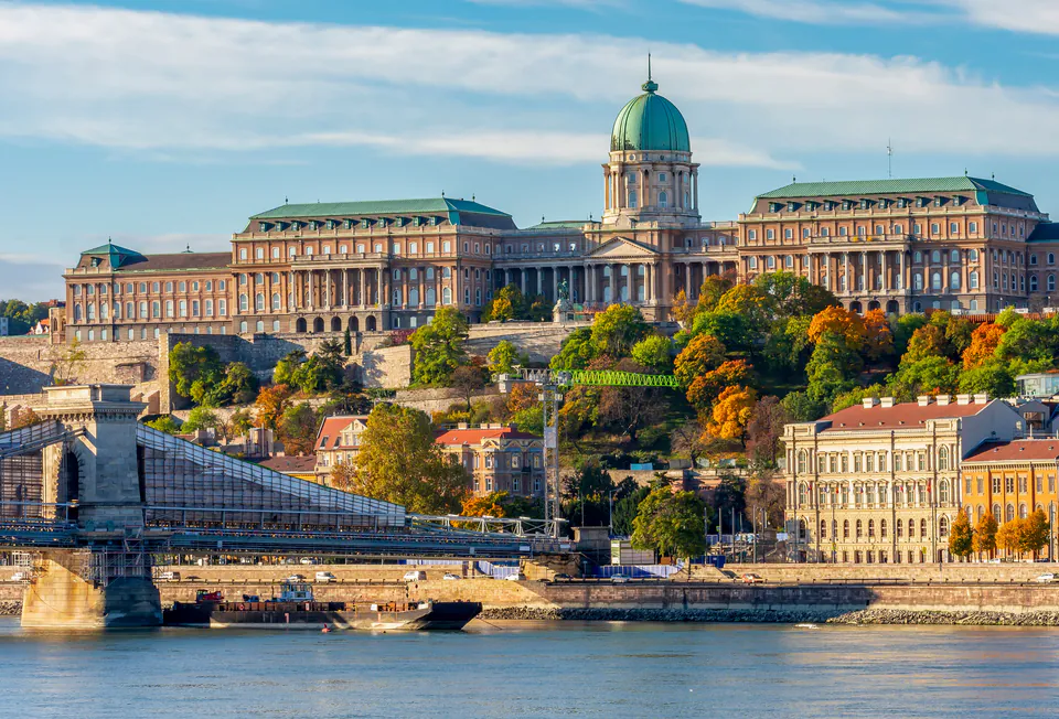 Buda Castle perched on hillside above Chain Bridge and Danube River in Budapest