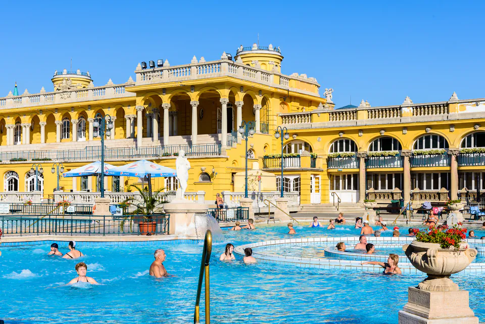 Outdoor thermal pools at Szechenyi Baths with people relaxing in steamy water