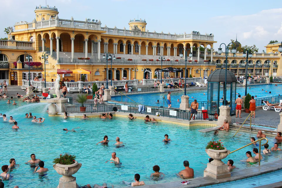 Multiple thermal pools with bathers enjoying different temperature zones at Széchenyi Baths