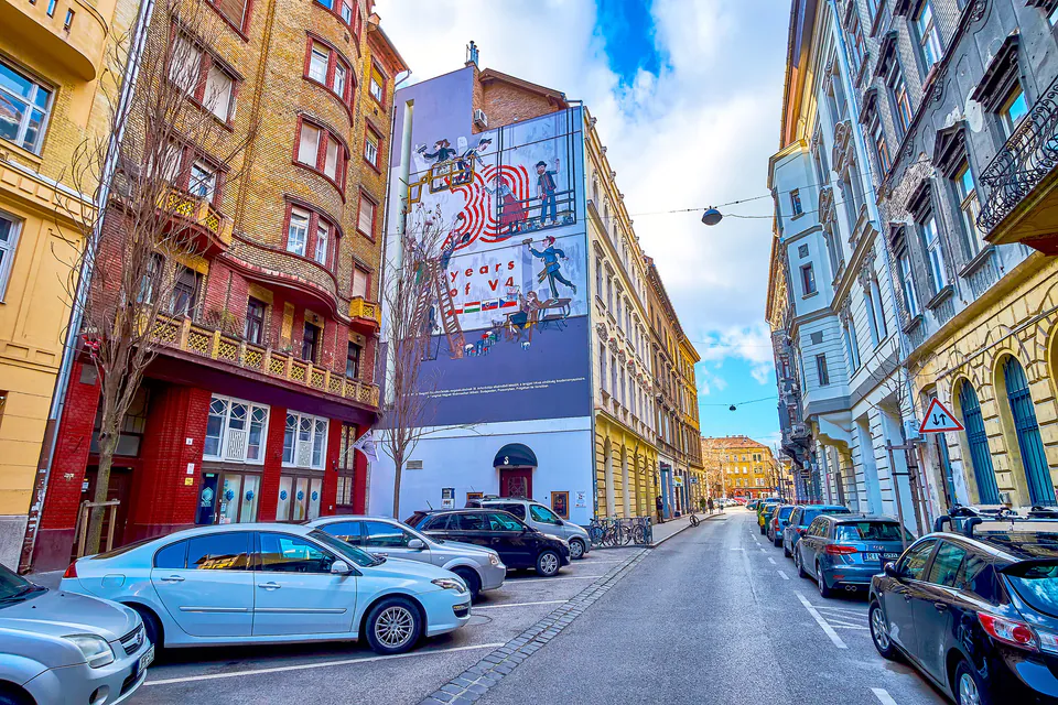 Colorful street art and vintage shops in Budapest Jewish Quarter with historic synagogue visible
