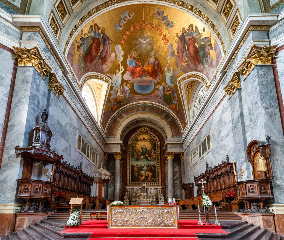 Ornate altar and ceiling frescoes inside Esztergom Basilica with marble columns and gilded details